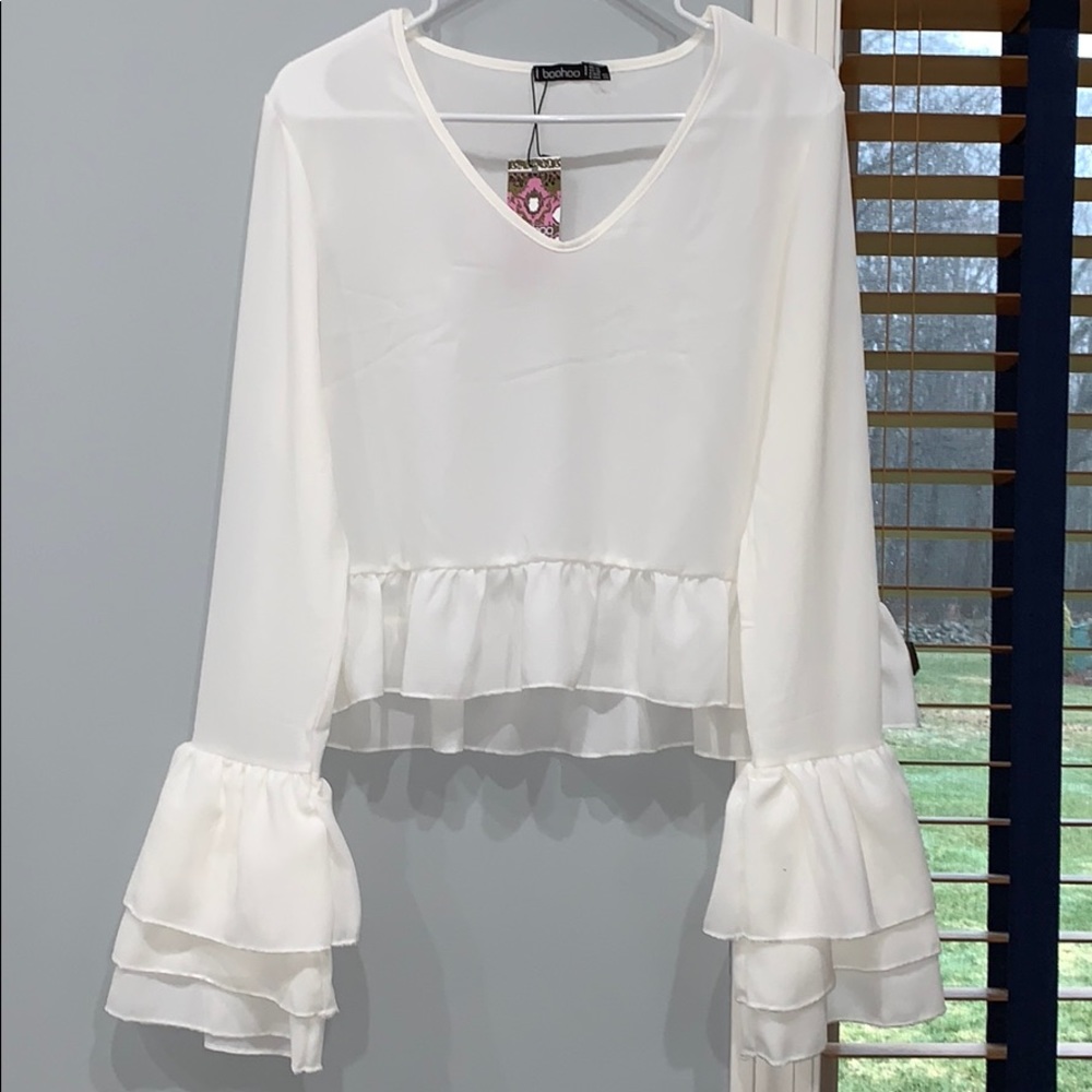 White long sleeved peplum top.